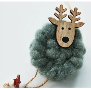 Macro detail of wool felt reindeer ornament with wooden star and rustic hemp rope hanger