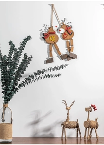 Close-up of wooden Christmas reindeer hanging ornaments and table figurines with eucalyptus