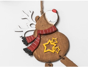 Detail of wooden Christmas reindeer ornament with red scarf and star on white background