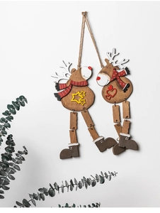 Detail of wooden Christmas reindeer ornaments with jute string hanging on a white wall
