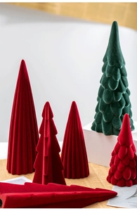 Detail of red and green flocked ceramic Christmas trees on a minimalist display