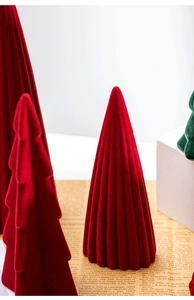 Close-up of velvet flocked ceramic Christmas tree ornaments with soft texture finish