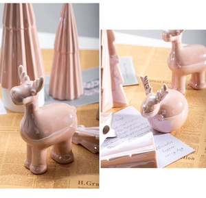 Detail of pink ceramic reindeer figurine with smooth glazed finish for Christmas decor