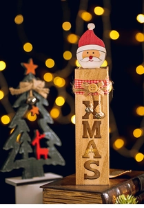 Macro detail of a lighted wooden Santa ornament with XMAS engraving and festive bells