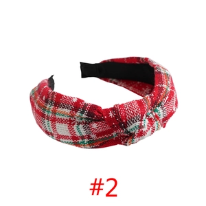 Close-up of red and green plaid fabric headband with a stylish knotted detail