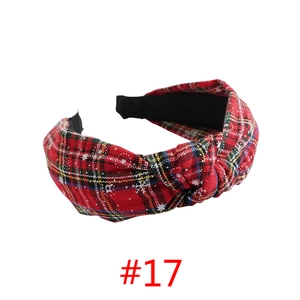 Detail of red plaid Christmas headband with white snowflake print and knot design