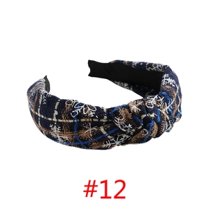 Detail of Christmas headband with navy blue snowflake pattern and twisted knot design
