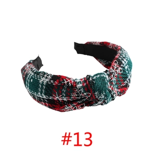 Detail of a knotted plaid headband with festive red and green snowflake embroidery