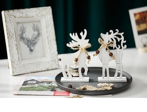 Detail of wooden Christmas reindeer figurines with rustic jute bows and beads