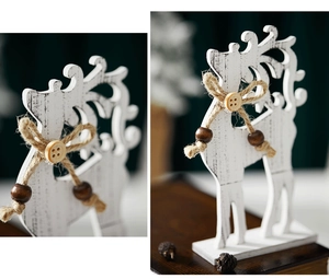 Detail of white wooden reindeer with rustic jute rope and wooden bead bow tie decoration