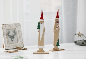 Close-up of hand-painted wooden Santa and Snowman ornaments with natural wood texture