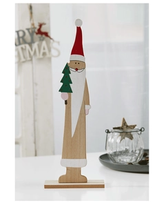 Detail of hand-painted wooden Santa Claus tabletop ornament with green Christmas tree