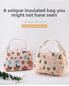 Detail of insulated lunch bags featuring orange and peach fruit patterns with canvas texture