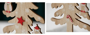 Detail of wooden Christmas tree decor with owl, candy cane and star patterns