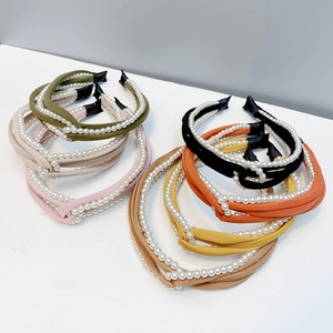 Collection of knotted chiffon headbands with white pearl accents in various soft colors
