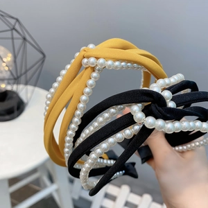 Elegant twisted wide headband with white pearls in yellow and black fabric finishes