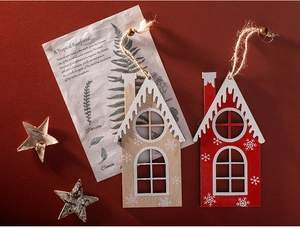 Close-up of red and natural wooden house ornaments with rustic twine and star detail