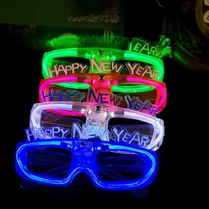 Set of five glowing Happy New Year 2026 LED glasses in green, pink, red, white, and blue colors