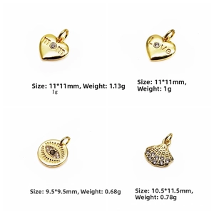 Macro view of gold heart and evil eye charms with Mom and Love engravings and zircons