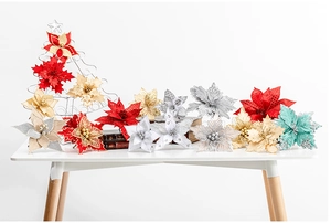 Detailed view of assorted glitter poinsettia flowers in red, gold, and silver for Christmas