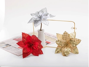 Close-up of sparkling 17cm artificial poinsettias in red, gold, and silver festive tones
