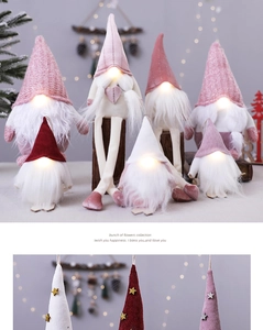 Close-up of glowing Christmas gnomes with warm LED light and knitted fabric texture