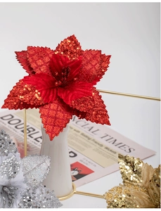 Detailed view of red, gold, and silver glitter poinsettia flowers for Christmas decoration