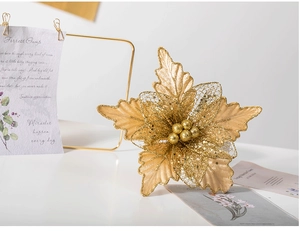 Detail of 24cm golden artificial poinsettia with glitter mesh and ball stamens