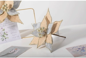 Detail of 26cm burlap poinsettia with gold glitter edges and metallic berry center