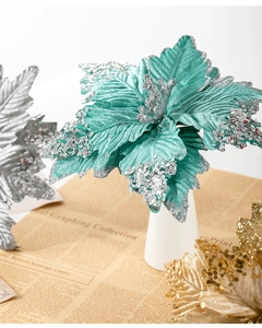 Macro shot of 25cm artificial turquoise poinsettia with glitters for Christmas decor