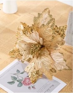 Detailed texture of 25cm champagne gold artificial poinsettia with glitter and sequins