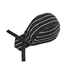 Detail of chef skull cap featuring black and white stripes and adjustable side straps