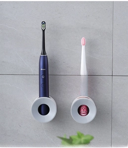 Wall-mounted electric toothbrush holder for both adult and child sized brushes