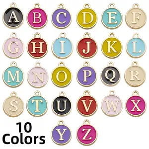 Detailed close-up of 26 gold-plated alloy alphabet charms in 10 vibrant enamel colors