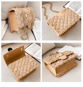 Detail view of beige plush crossbody bag with gold chain strap and metal ring buckle