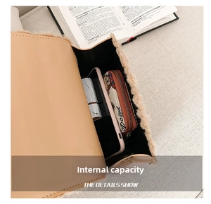 Interior view showing the capacity of the fuzzy crossbody bag with phone and lipstick