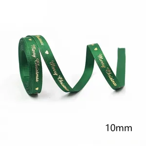 Detail of 10mm green Christmas ribbon with gold Merry Christmas print and heart patterns