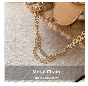 Detail of golden metal chain and soft light brown faux fur texture on a small crossbody bag