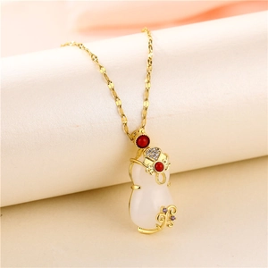 Gold Cheongsam pendant necklace with jade gourd and red gemstones on beige fabric