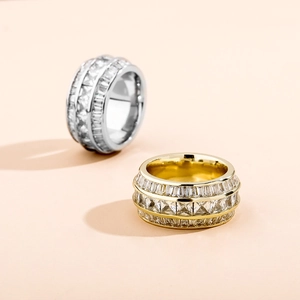 Close-up of gold and silver plated baguette cut zircon rings with hip hop bling style