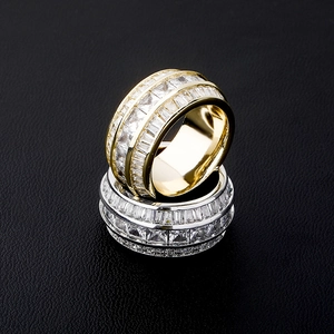 Macro detail of triple-row gold and silver baguette rings with sparkling stones