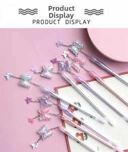 Detail of macaron-colored butterfly pendant pens with sequins and metal chain charms