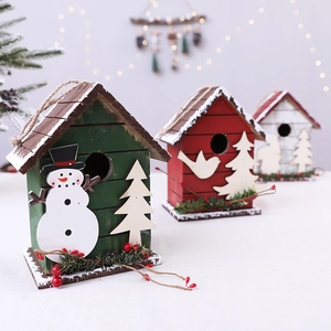 Three wooden Christmas birdhouse ornaments in red white and green with snowman and tree motifs