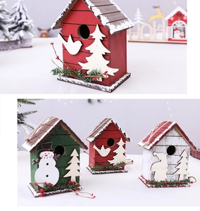 Close-up of wooden Christmas birdhouse ornaments with snowman and tree designs