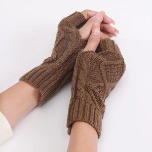 Close-up of brown diamond cable-knit fingerless gloves with detailed wool texture
