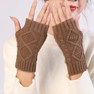 Detailed knit texture of brown diamond pattern fingerless gloves on a soft background