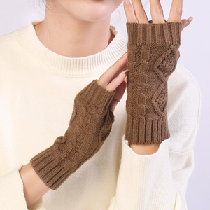 Close-up of diamond pattern knit texture on warm brown fingerless arm warmers