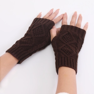 Close-up of dark brown knit fingerless gloves with diamond cable stitch texture
