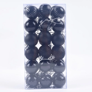 Detail of 36 black Christmas ornaments with matte, glossy, and glitter textures in a clear box