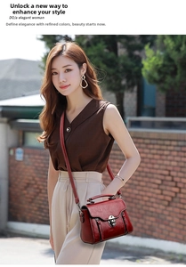 Close-up of wine red retro handbag with vintage metal turn-lock and elegant top handle